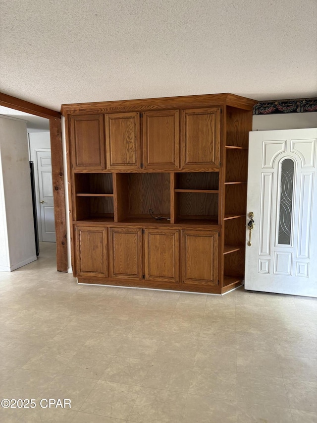 5360 Constitution Rd, Crestview, FL 32539 - unfurnished living room featuring a textured ceiling and light flooring