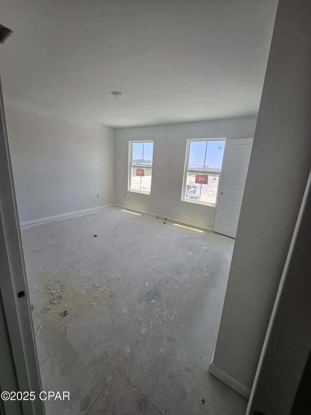 7682 Solana Ln Unit 55, Panama City Beach, FL 32407 - spare room featuring baseboards