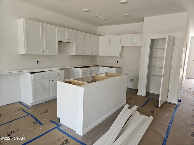 7682 Solana Ln Unit 55, Panama City Beach, FL 32407 - kitchen featuring a center island and white cabinets