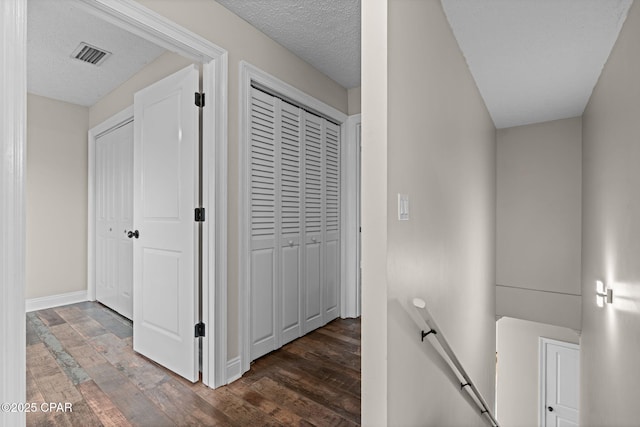 2932 Palmetto Ridge Way, Lynn Haven, FL 32444 - hall featuring an upstairs landing, wood finished floors, and a textured ceiling