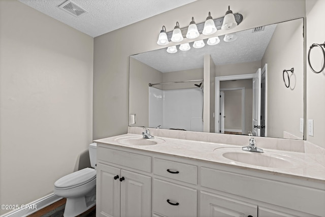 2932 Palmetto Ridge Way, Lynn Haven, FL 32444 - full bathroom featuring a textured ceiling, double vanity, a shower, and wood finished floors