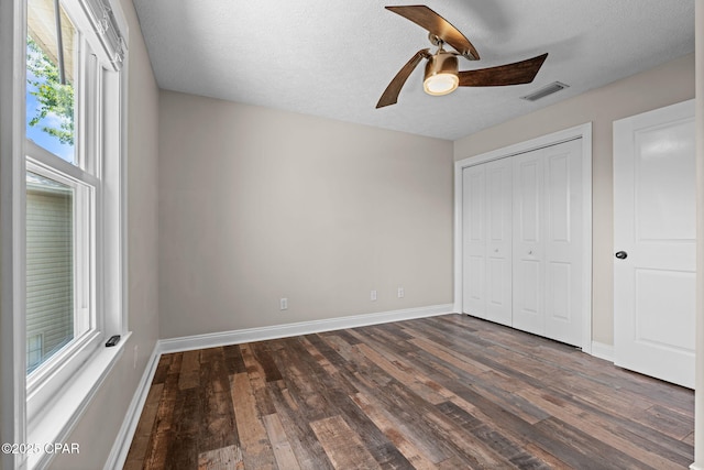 2932 Palmetto Ridge Way, Lynn Haven, FL 32444 - unfurnished bedroom featuring dark wood-style flooring, a closet, a ceiling fan, and a textured ceiling