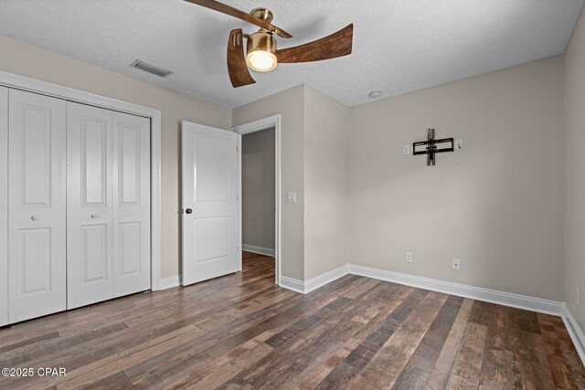 2932 Palmetto Ridge Way, Lynn Haven, FL 32444 - unfurnished bedroom with wood finished floors, a closet, a textured ceiling, and a ceiling fan
