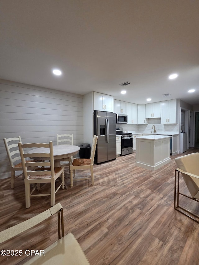 116 Damon Cir Unit C, Panama City Beach, FL 32407 - kitchen with stainless steel appliances, light wood-type flooring, white cabinetry, light countertops, and recessed lighting