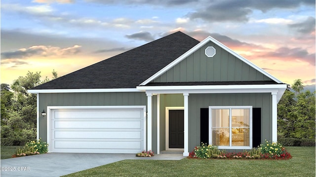 698 Norris Dr, Port St Joe, FL 32456 - view of front of home with a shingled roof, concrete driveway, a garage, and a lawn