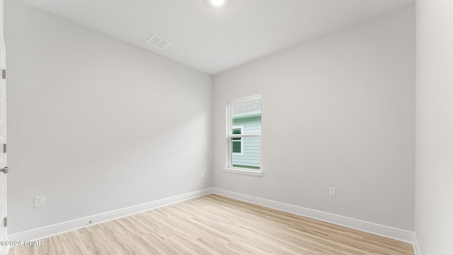 698 Norris Dr, Port St Joe, FL 32456 - unfurnished room with light wood-type flooring and vaulted ceiling