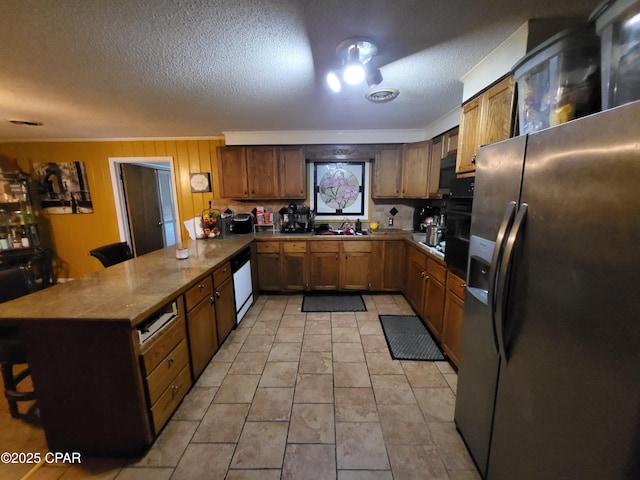 4010 Old Cottondale Rd, Marianna, FL 32448 - kitchen featuring stainless steel refrigerator with ice dispenser, a peninsula, white dishwasher, a textured ceiling, and brown cabinetry