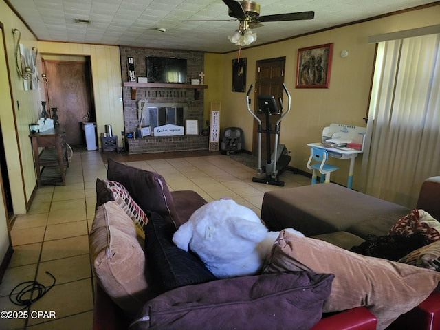 4010 Old Cottondale Rd, Marianna, FL 32448 - living room featuring a fireplace, light tile patterned floors, a ceiling fan, and wooden walls