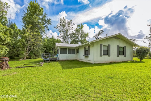3127 4th St, Marianna, FL 32446 - back of property featuring a deck, a yard, and a metal roof