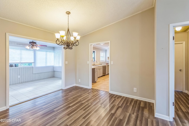 3127 4th St, Marianna, FL 32446 - unfurnished dining area with wood finished floors, crown molding, a textured ceiling, a chandelier, and ceiling fan