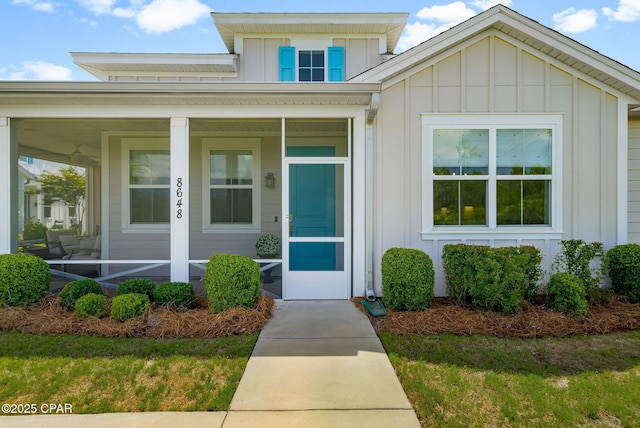 8648 Conch Shell Ct, Panama City Beach, FL 32413 - view of exterior entry featuring board and batten siding and covered porch