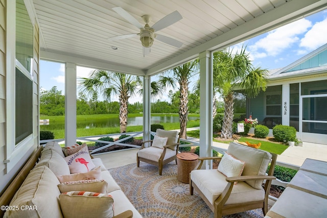 8648 Conch Shell Ct, Panama City Beach, FL 32413 - sunroom / solarium with a water view, a ceiling fan, an outdoor living space, and view of wooded area