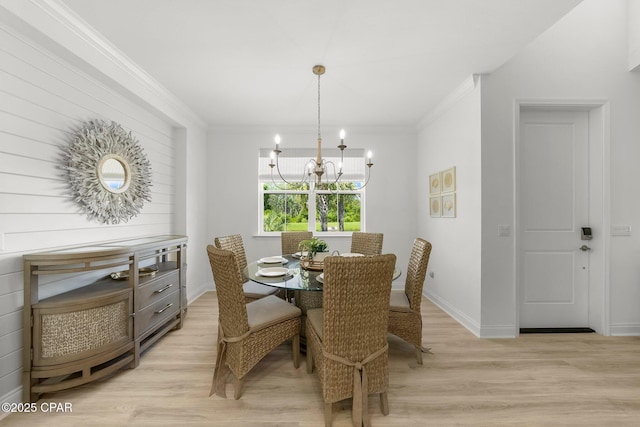 8648 Conch Shell Ct, Panama City Beach, FL 32413 - dining space with a chandelier, light wood finished floors, and ornamental molding