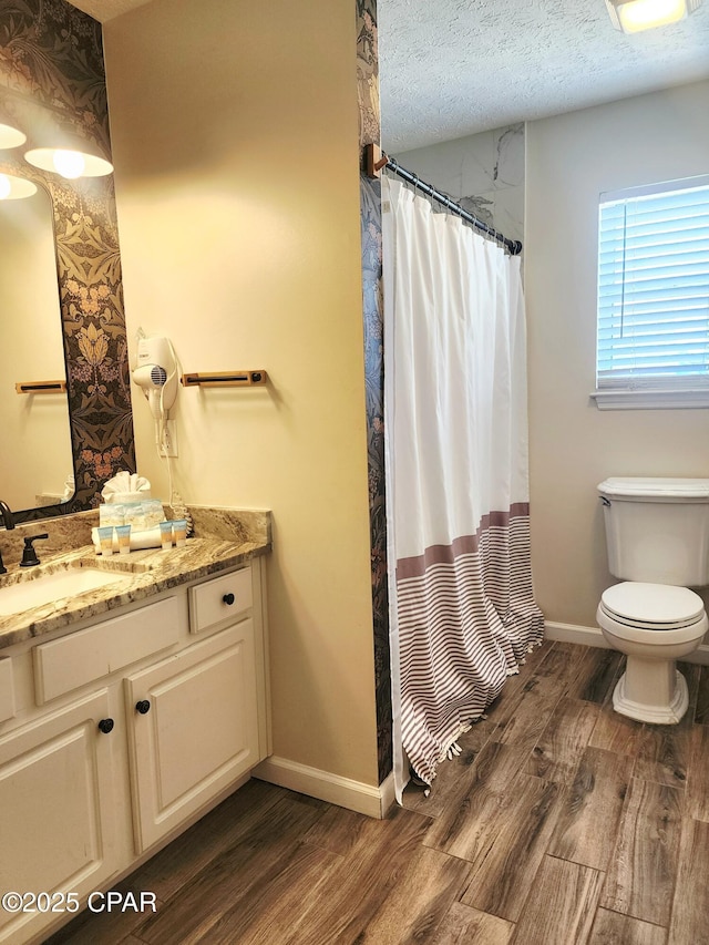 184 White Cap Way, Panama City Beach, FL 32407 - bathroom with wood finished floors, vanity, a textured ceiling, and a shower with shower curtain
