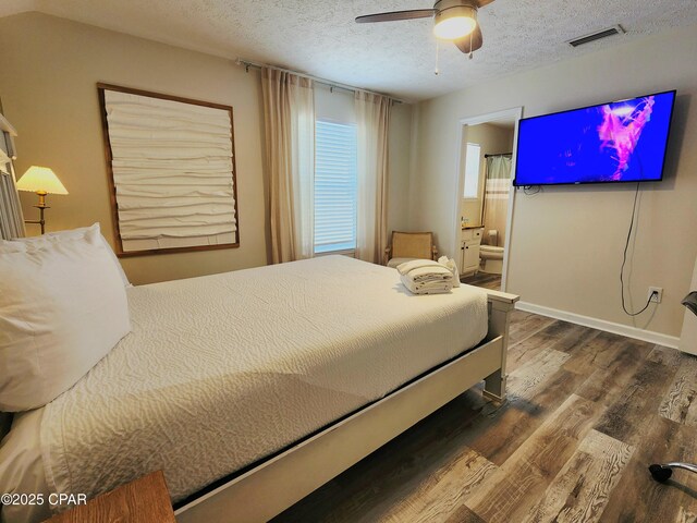 184 White Cap Way, Panama City Beach, FL 32407 - bedroom featuring wood finished floors, a textured ceiling, ensuite bathroom, and a ceiling fan