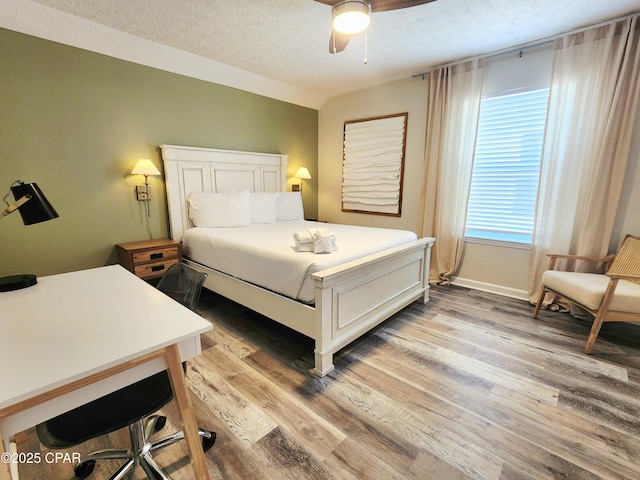184 White Cap Way, Panama City Beach, FL 32407 - bedroom with a textured ceiling, light wood-style floors, and ceiling fan