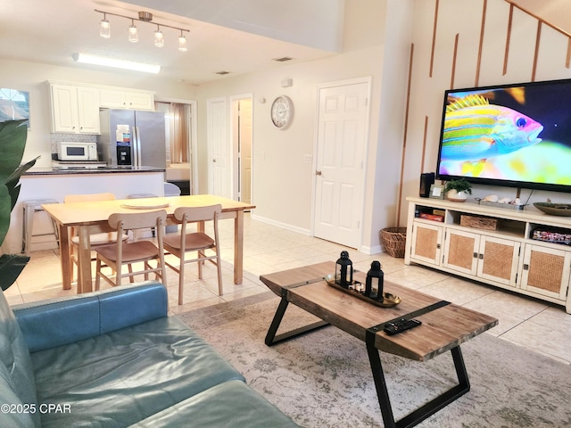 184 White Cap Way, Panama City Beach, FL 32407 - living area featuring light tile patterned flooring and rail lighting