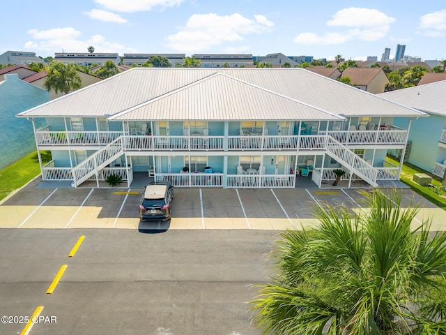 17642 Front Beach Rd Unit B1, Panama City Beach, FL 32413 - view of building exterior with stairs and uncovered parking