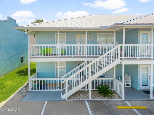 17642 Front Beach Rd Unit B1, Panama City Beach, FL 32413 - view of property with uncovered parking and stairway