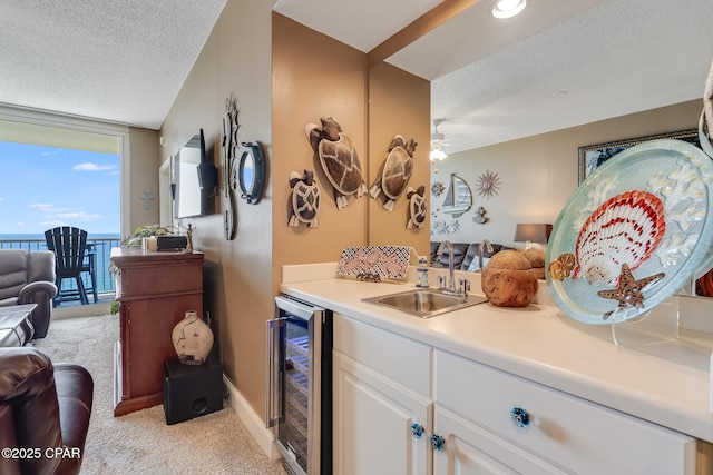 10811 Front Beach Rd Unit 2304, Panama City Beach, FL 32407 - indoor bar with beverage cooler, light colored carpet, a textured ceiling, a ceiling fan, and a wall of windows