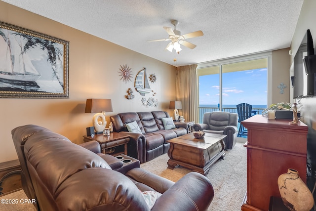 10811 Front Beach Rd Unit 2304, Panama City Beach, FL 32407 - carpeted living room with floor to ceiling windows, a ceiling fan, and a textured ceiling