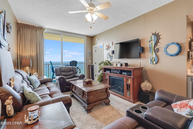 10811 Front Beach Rd Unit 2304, Panama City Beach, FL 32407 - living room featuring expansive windows, ceiling fan, and a textured ceiling
