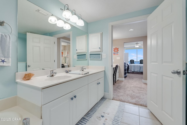 10811 Front Beach Rd Unit 2304, Panama City Beach, FL 32407 - bathroom with double vanity, connected bathroom, ceiling fan, and tile patterned floors