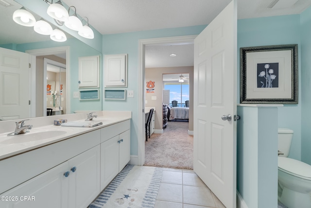 10811 Front Beach Rd Unit 2304, Panama City Beach, FL 32407 - bathroom featuring double vanity, ensuite bathroom, tile patterned floors, and a ceiling fan