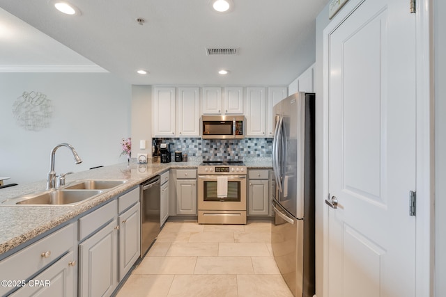 10713 Front Beach Rd Unit 904, Panama City Beach, FL 32407 - kitchen with appliances with stainless steel finishes, ornamental molding, tasteful backsplash, recessed lighting, and white cabinets