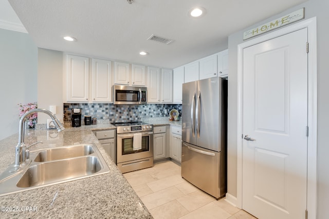 10713 Front Beach Rd Unit 904, Panama City Beach, FL 32407 - kitchen featuring appliances with stainless steel finishes, light countertops, decorative backsplash, white cabinets, and recessed lighting