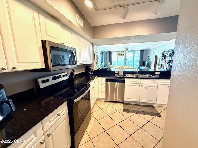 14701 Front Beach Rd Unit 536, Panama City Beach, FL 32413 - kitchen with stainless steel appliances, light tile patterned floors, dark countertops, and white cabinetry