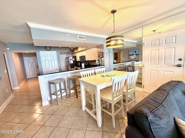 14701 Front Beach Rd Unit 536, Panama City Beach, FL 32413 - dining room with ornamental molding and light tile patterned floors