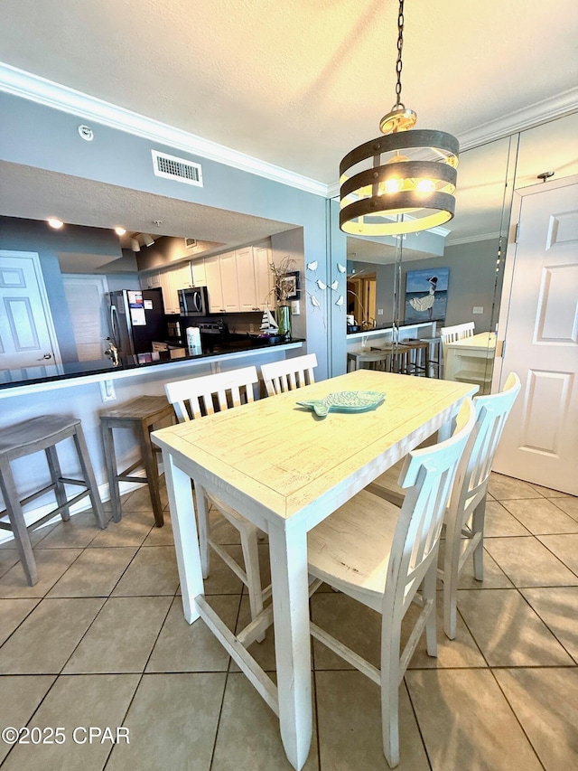 14701 Front Beach Rd Unit 536, Panama City Beach, FL 32413 - dining room featuring ornamental molding and light tile patterned floors