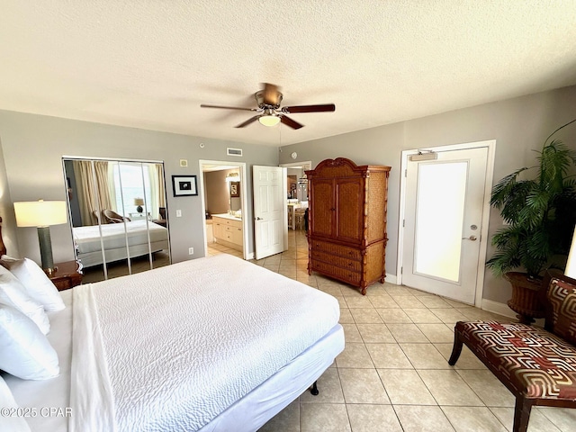 14701 Front Beach Rd Unit 536, Panama City Beach, FL 32413 - bedroom featuring light tile patterned flooring, a ceiling fan, ensuite bathroom, and a textured ceiling