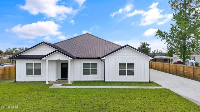 1306 E 26th St, Lynn Haven, FL 32444 - modern inspired farmhouse featuring board and batten siding, a metal roof, and driveway