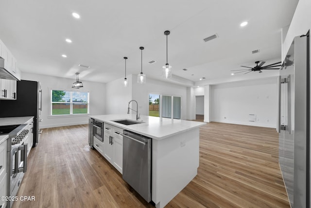 1306 E 26th St, Lynn Haven, FL 32444 - kitchen with appliances with stainless steel finishes, white cabinets, light countertops, light wood-type flooring, and recessed lighting