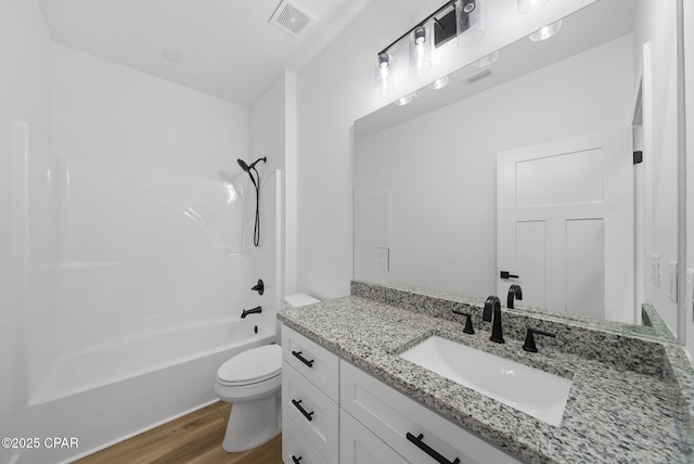 1306 E 26th St, Lynn Haven, FL 32444 - full bath with vanity, wood finished floors, and shower / washtub combination