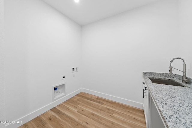1306 E 26th St, Lynn Haven, FL 32444 - washroom with hookup for an electric dryer, cabinet space, light wood-type flooring, and hookup for a washing machine