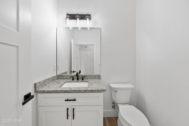 1306 E 26th St, Lynn Haven, FL 32444 - half bath featuring vanity and wood finished floors