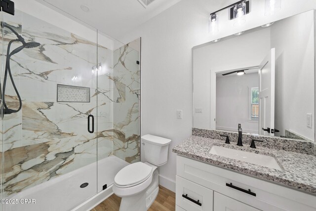1306 E 26th St, Lynn Haven, FL 32444 - full bath with a marble finish shower, vanity, and wood finished floors