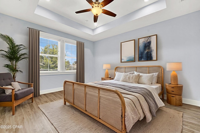 112 Christopher Dr Unit B, Panama City Beach, FL 32413 - bedroom featuring a raised ceiling, light wood-style flooring, ceiling fan, and recessed lighting