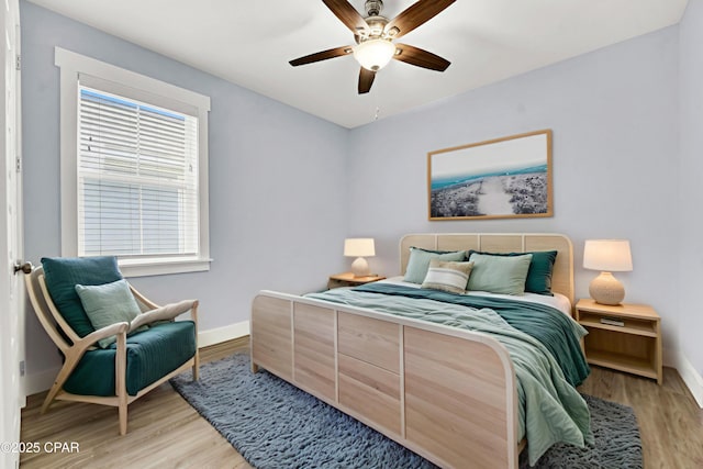 112 Christopher Dr Unit B, Panama City Beach, FL 32413 - bedroom with light wood-style floors and ceiling fan