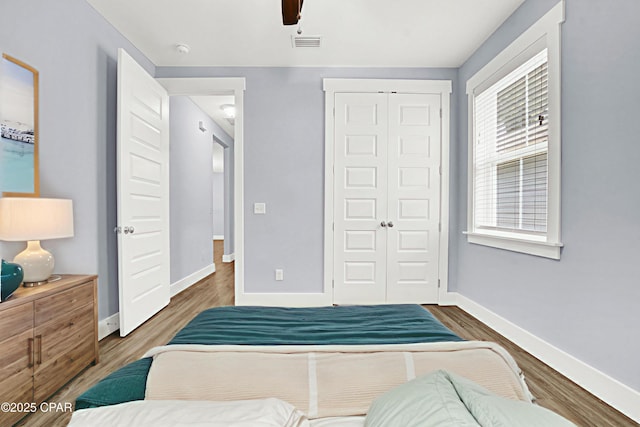 112 Christopher Dr Unit B, Panama City Beach, FL 32413 - bedroom with a closet, wood finished floors, and ceiling fan