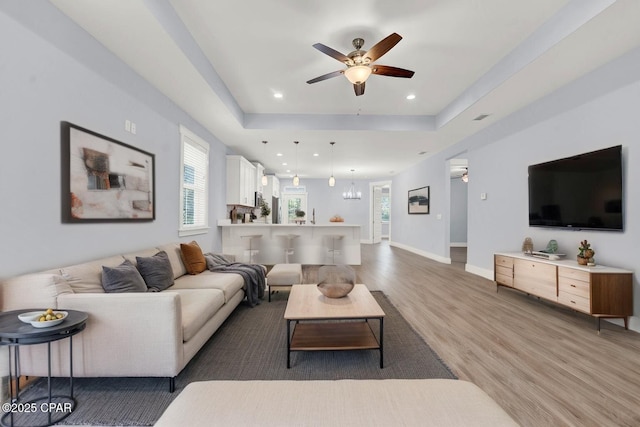 112 Christopher Dr Unit B, Panama City Beach, FL 32413 - living area with light wood finished floors, a ceiling fan, a raised ceiling, a chandelier, and recessed lighting