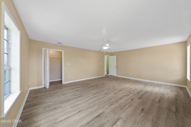 1601 Loblolly Ln, Lynn Haven, FL 32444 - empty room with a ceiling fan, light wood finished floors, and plenty of natural light