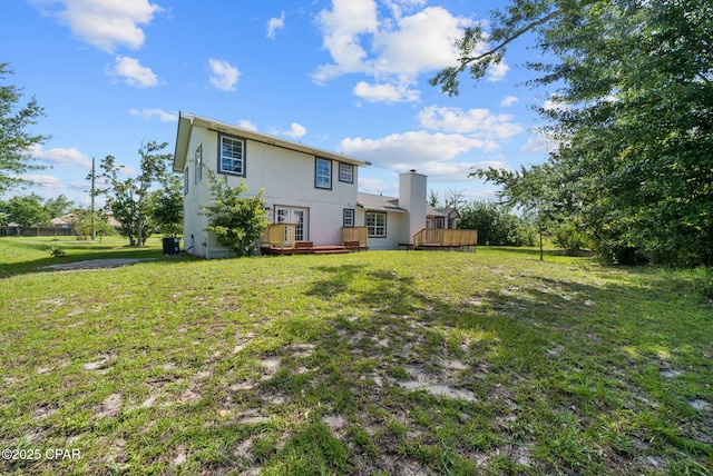 1601 Loblolly Ln, Lynn Haven, FL 32444 - rear view of property featuring a wooden deck, a lawn, stucco siding, a chimney, and french doors