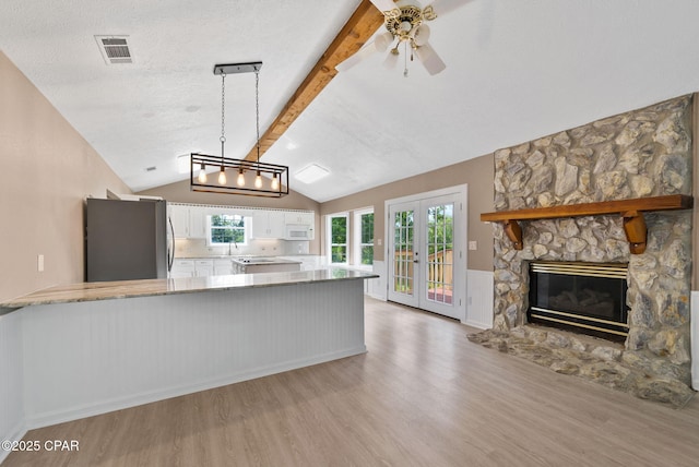 1601 Loblolly Ln, Lynn Haven, FL 32444 - kitchen featuring freestanding refrigerator, light wood-type flooring, white cabinets, white microwave, and a ceiling fan