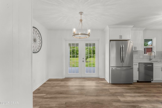 2020 Greenbriar Blvd, Lynn Haven, FL 32444 - kitchen with appliances with stainless steel finishes, a chandelier, dark wood finished floors, white cabinetry, and light countertops