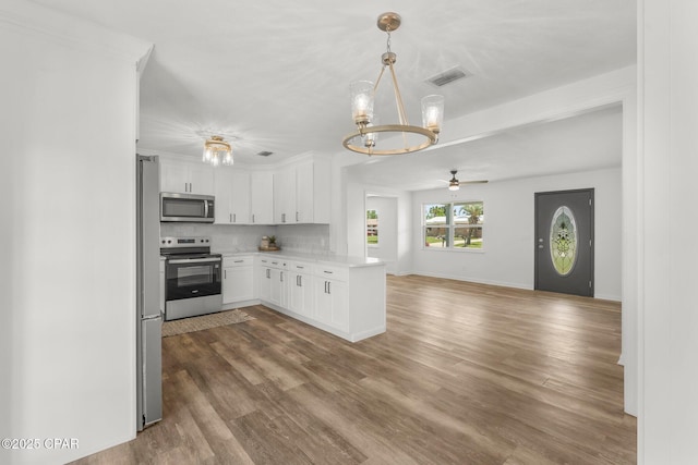 2020 Greenbriar Blvd, Lynn Haven, FL 32444 - kitchen with appliances with stainless steel finishes, a chandelier, open floor plan, a ceiling fan, and light countertops