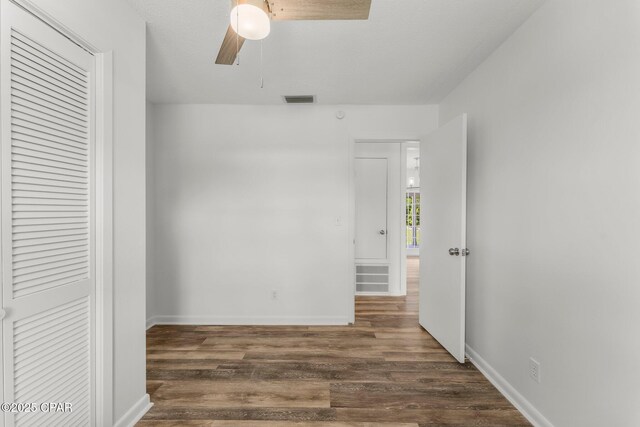 2020 Greenbriar Blvd, Lynn Haven, FL 32444 - unfurnished bedroom with dark wood-style floors, ceiling fan, and a closet